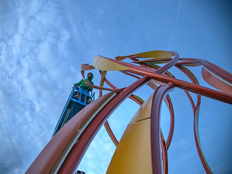 Construction image of curved steel sculpture "Be the Light" by Curtis Pittman